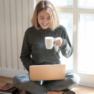 woman-in-gray-sweater-drinking-coffee-3759089