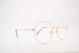 Gold glasses on white background