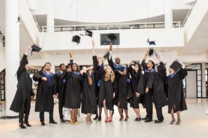 Graduates throwing their mortarboard hats up in the air