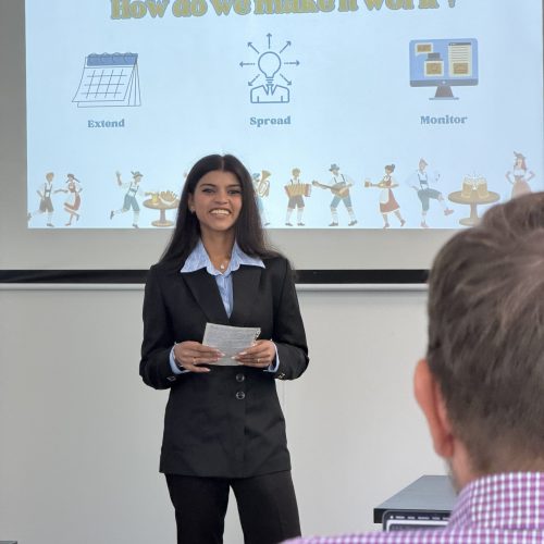 Students presenting and smiling